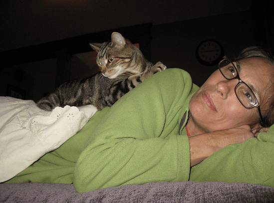 cat lying on woman