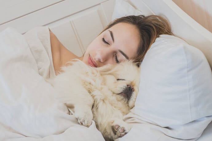 woman sleeping with a dog