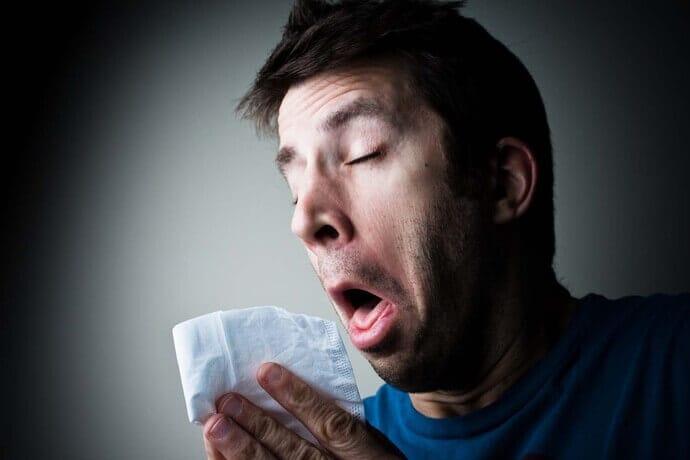sneezing man with allergy